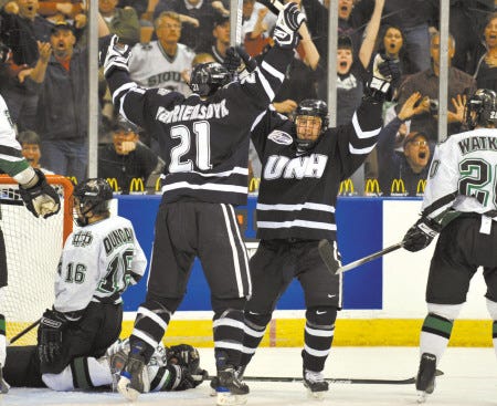 University of New Hampshire teammates Thomas Fortney (right) and James van Riemsdyk (21) celebrate Fortney’s game-tying goal with 0.1 seconds left in the third period of Saturday’s NCAA tournament game against North Dakota. The Wildcats won in overtime, 6-5, and will play Boston University in today’s Northeast Region final.