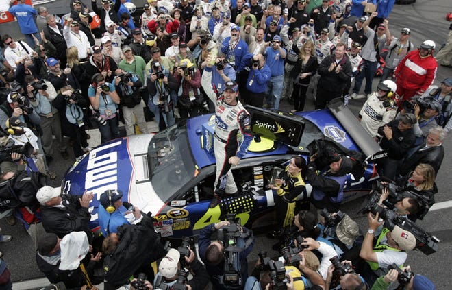 Jimmie Johnson celebrates winning the Goody's Fast Pain Relief 500 at Martinsville Speedway. Johnson passed Denny Hamlin with 15 laps to go Sunday to pick his sixth victory at the track.