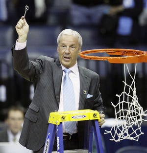 UNC coach Roy Williams helps cut down the net after his team won the South Regional yesterday in Memphis, Tenn.