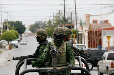 Mexican Army soldiers on patrol in Reynosa, a border town. A cartel has hired a paramilitary force to protect its turf there.