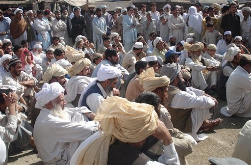 Pakistani people from the Mehsud tribe rally to condemn reported U.S. missile attacks in their area along the Afghanistan border, in Tank, 60 kilometers (37 miles) from Dera Ismail Khan, in Pakistan, Wednesday, April 1, 2009. A suspected U. S. drone fired two missiles at an alleged hide-out connected to a Taliban leader who has threatened to attack Washington, killing 12 people and wounding several others, officials said. (AP Photo / Ishtiaq Mehsud)