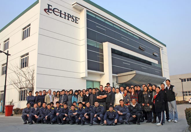 Employees stand outside Eclipse Inc.'s new factory and offices in Sanzhou, China.