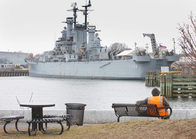 Joe Donnelly of Carver takes a break from work on the Weymouth bank of the Fore River. Across the river is the USS Salem.