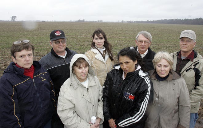 John Schroeder (left in back), Karalyn Schultz, Larry Weber, Rich Ott and Ann Schroeder (left front), Dee Ott, Mary Wallis and Toni Weber stand Tuesday, March 31, 2009, in front of the proposed Cannell subdivision in Rockton Township.