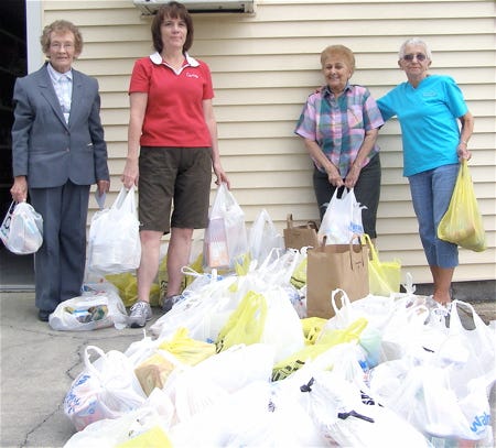 Recently, members of the fitness club, Curves of Gonzales, owned by Sandi Scott, conducted their annual food drive to assist the needy in Ascension Parish. Members of Curves brought in food items totaling 463 pounds. The food was donated to the Holy Rosary Church food pantry which is handled by the Holy Rosary Community Responsibility Committee, organized June 15, 1976. Left, shown during the delivery are, from left, Ronie Tureau, Holy Rosary food pantry chairperson; Rhonda Everett, Curves trainer; Marie McClendon and Dora Westbrook, Curves members.