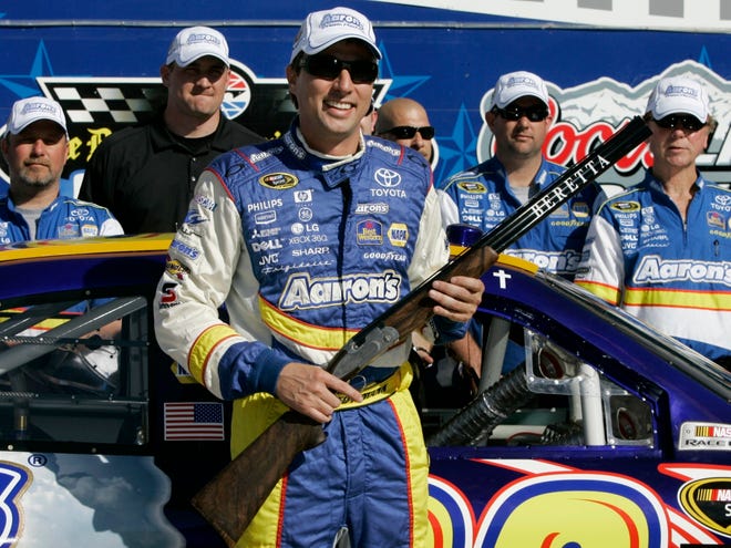 David Reutimann holds the SAMSUNG 500 pole award Friday in Victory Lane at Texas Motor Speedway in Fort Worth, Texas.