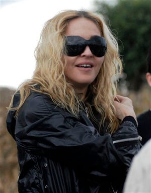 U.S. singer Madonna visits a devolvement project today in Gumulira, Malawi. In a surprise move, a judge rejected Madonna's request to adopt a second child from Malawi and said it would set a dangerous precedent to bend rules requiring that prospective parents live here for some period.