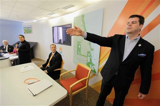 In this March 24, 2009, file photo, Patrick Sandusky, spokesman for Chicago 2016, shows off the strategy office of Chicago 2016 in Chicago. (AP Photo/M. Spencer Green, File)