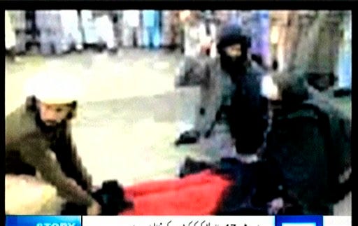 This is image from mobile phone footage released by Dunya TV Channel shows a woman in a body-covering burqa face down on the ground with two men holding her arms and feet and a third man whipping her backside, on Friday, April 3, 2009. Pakistani authorities ordered an investigation Friday, April 3, 2009, into a video showing a man flogging a screaming woman in the country's northwest where the government recently agreed to introduce Islamic law to end a rebellion by Taliban militants. (AP Photo/Dunya TV Channel) THE ASSOCIATED PRESS IS UNABLE TO INDEPENDENTLY VERIFY THE AUTHENTICITY, CONTENT, LOCATION OR DATE OF THIS HANDOUT IMAGE FROM VIDEO RELEASED BY DUNYA TV