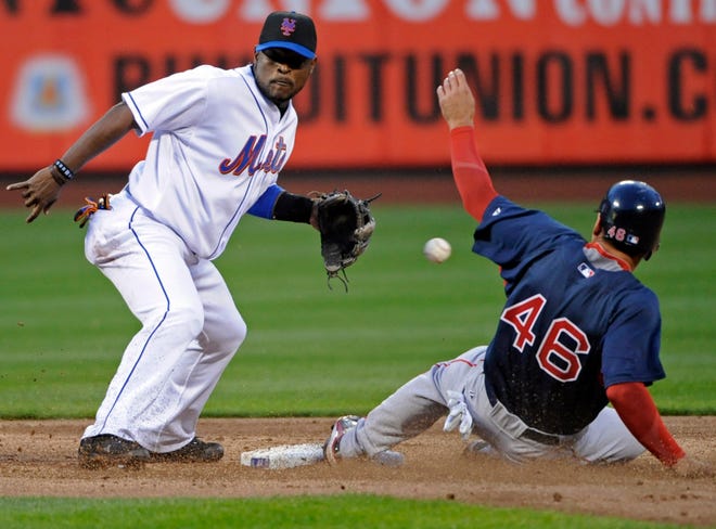 Red Sox outfielder Jacoby Ellsbury (right) slides into second with a stolen base as the ball gets away from Mets second baseman Luis Castillo during the third inning of last night's game at Citi Field in New York.