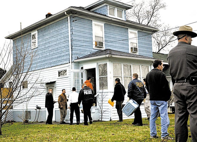 Authorities enter a Johnson City, N.Y. home belonging to the suspected gunman in the Binghamton shooting.