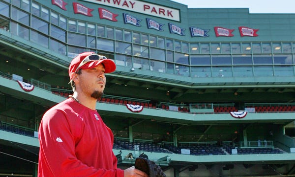 Boston Red Sox starting pitcher Josh Beckett takes the field during baseball workouts at Fenway Park, Sunday in Boston. The Boston Red Sox open their season against the Tampa Bay Rays today.