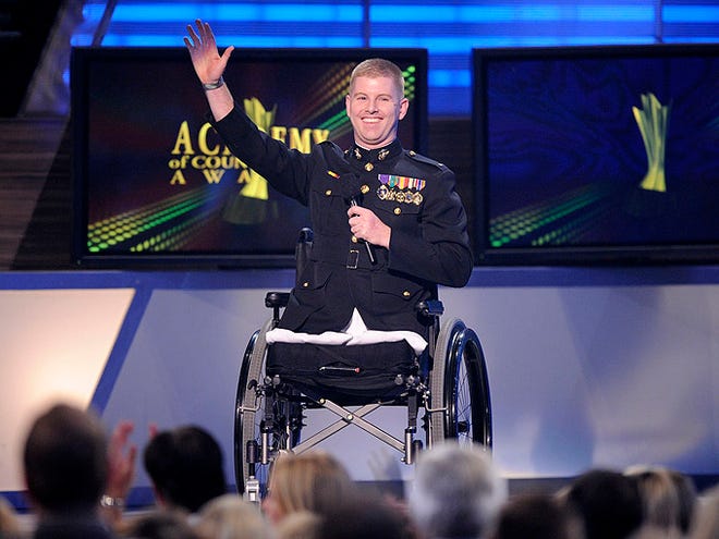 Lt. Andrew Kinard presents the performance by Trace Adkins at the 44th Annual Academy of Country Music Awards in Las Vegas on Sunday.