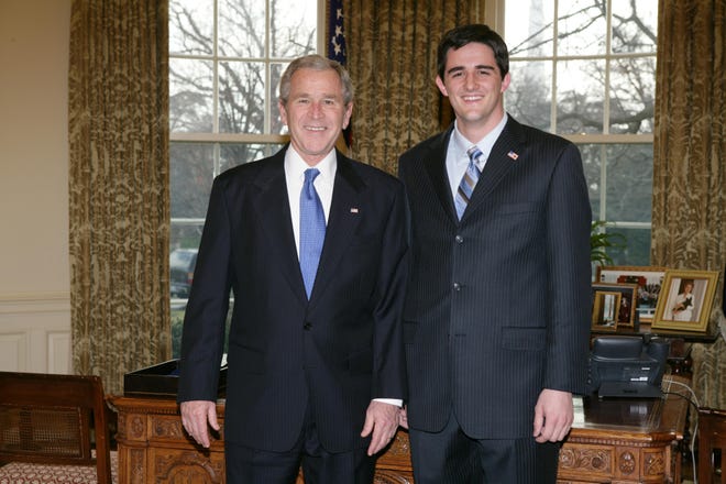 Matt Adkins, 24, a Fillmore Township native and Hope College grad, is pictured with President George W. Bush.