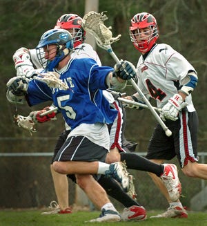 Scituate's Wesley Hawkins (5) takes ball down the field, as Hingham's Eric Hawkins (3) tries to stop him.