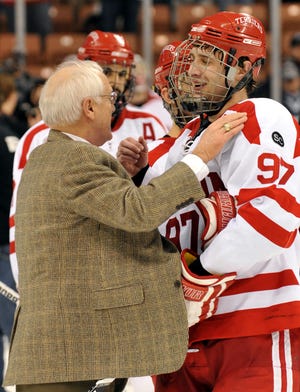 Boston University coach Jack Parker congratulates captain Matt Gilroy after BU defeated New Hampshire 2-1 in the NCAA Northeast Regional championship game in Manchester, N.H., on Sunday.