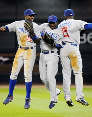 Chicago Cubs' Alfonso Soriano (12), Joey Gathright, center, and Milton Bradley celebrate the Cubs' 11-6 win over the Houston Astros in a baseball game Wednesday, April 8, 2009, in Houston. (AP Photo/Pat Sullivan)