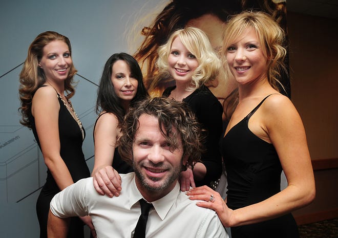 Hairstylist David Glover, center, has created looks for fashion shows, music videos and magazine shoots. Here, Glover shows off the hairstyles of a group of models he has just finished styling.