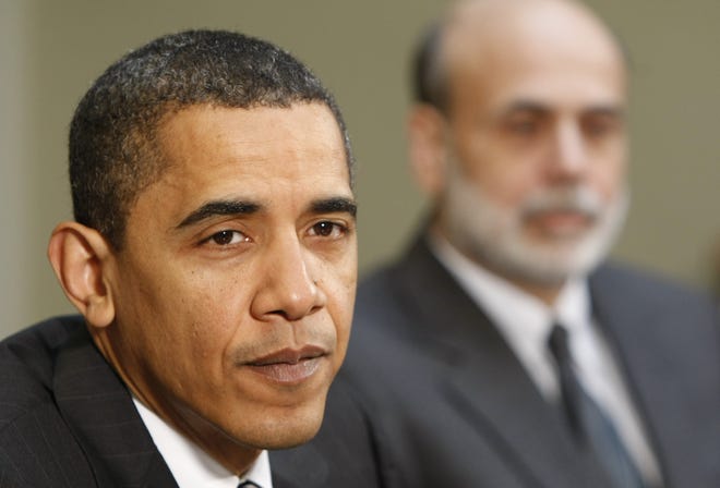 President Barack Obama, accompanied by his economic advisers, makes remarks Friday, April 10, 2009, in the Roosevelt Room of the White House in Washington. At right is Federal Reserve Chairman Ben Bernanke.