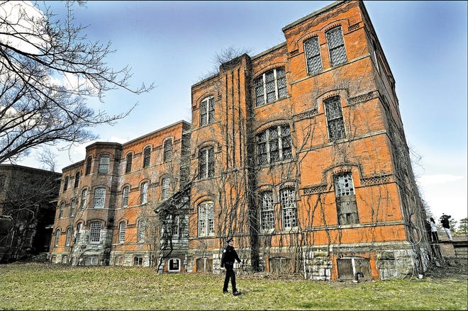 Middletown police Lt. Paul Rickard checks the old Main Building at the former Middletown Psychiatric Center, where 20 Washingtonville-area teenagers were arrested Wednesday night and charged with trespassing.