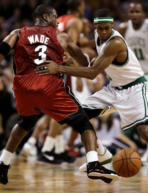 Celtics guard Rajon Rondo picks the pocket of Heat guard Dwyane Wade during the first half of Friday night's game. Rondo had seven points, 10 rebounds and 12 assists in the 105-98 victory.