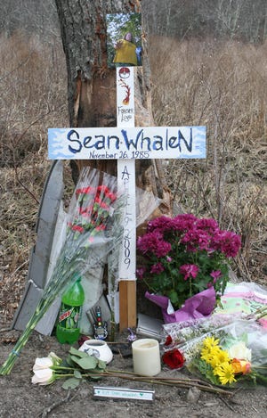 A memorial stands as a tribute to accident victim Sean Whalen on High Street in Bellingham on Friday.