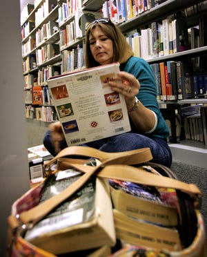 Rose Taylor looks through cookbooks at the Alachua County Library District Headquarters on Wednesday in Gainesville.