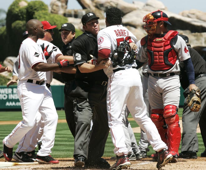 Angels outfielder Bobby Abreu (center) is restrained after a Josh Beckett pitch came in high and tight.