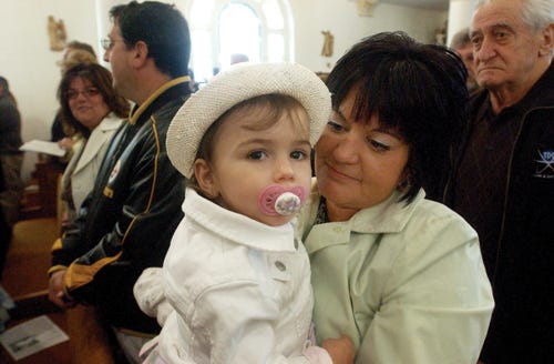 Two-year-old Carina and mother Angela Almada at Holy Family Church.