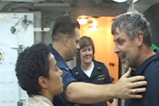 In this image made from video provided by the U.S. Navy, Maersk Alabama Capt. Richard Phillips, right, is welcomed aboard the USS Bainbridge on Sunday, April 12, 2009 after being rescued by U.S. naval forces off the coast of Somalia. Philips was held hostage for four days by pirates.