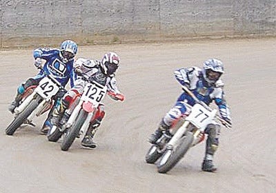 Motorcycle racers take on the turn at Oakland Valley Race Park on April 4.