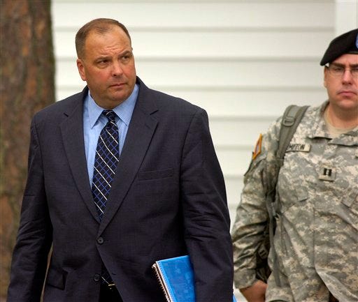 Charles Gittins, left, defense counsel for U.S. Army Sgt. Joseph C. Bozicevich, walks out of the courtroom during a break in Bozicevich's Article 32 hearing, Monday, April 13, 2009, in Fort Stewart, Ga. Bozicevich is charged with the murder of Sgt. Wesley Durbin and Staff Sgt. Darris Dawson in September of 2008 while deployed in Iraq. (AP Photo/Stephen Morton)