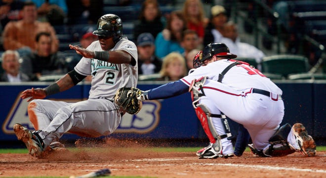Florida Marlins' Hanley Ramirez is tagged out by Atlanta Braves catcher Brian McCann as he tries to score on a Dan Uggla base hit in the eighth inning of a baseball game Tuesday, April 14, 2009, in Atlanta. (AP Photo/John Bazemore)