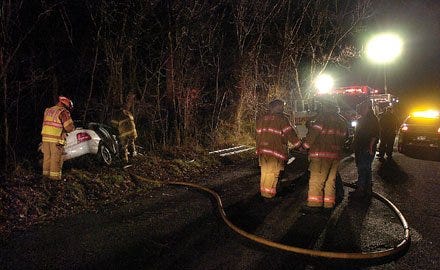 Times photo by SYLVESTER WASHINGTON Jr. Emergency personnel work at the scene of an accident Wednesday night in Chippewa Township.