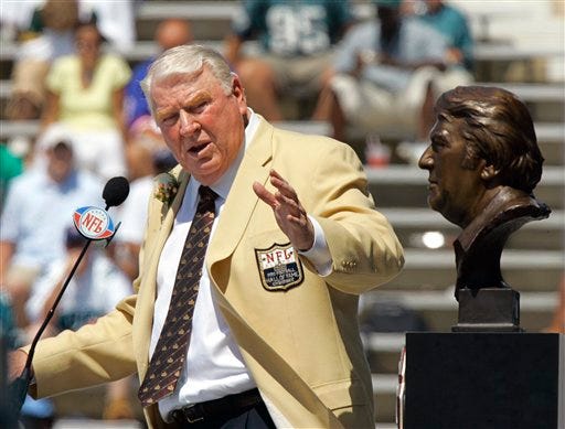 In this Aug. 5, 2006, file photo, former Oakland Raiders coach John Madden gestures toward his bust during his enshrinement into the Pro Football Hall of Fame in Canton, Ohio. Madden, 73, the burly former head coach who worked as a broadcast analyst for all four major networks, is calling it quits. Madden worked for the past three seasons on NBC's Sunday night NFL game. His last telecast was the Super Bowl between Arizona and Pittsburgh. (AP Photo/Mark Duncan, file)