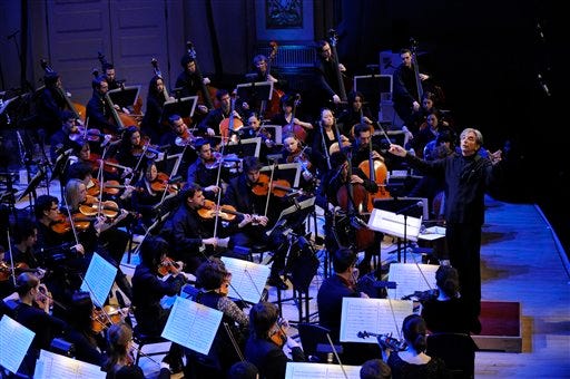 In this image released by Stefan Cohen Photography, Conductor Michael Tilson Thomas, standing right, rehearses with the YouTube Symphony Orchestra at Carnegie Hall in New York on Wednesday, April 15, 2009. (AP Photo/Stefan Cohen Photography, Stefan Cohen)