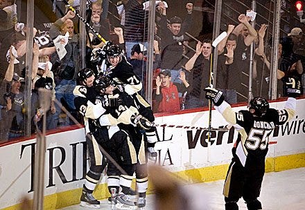 Times photo by KEVIN LORENZI Members of the Pittsburgh Penguins celebrate Bill Guerin's game-winning goal in overtime of Friday's 3-2 Penguins win over Philadelphia.
