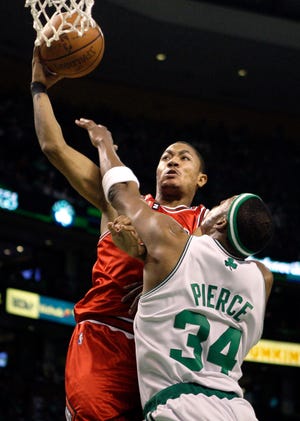 Chicago Bulls guard Derrick Rose (left) takes it to the hoop against Boston Celtics forward Paul Pierce during the first half in Boston Saturday, April 18, 2009.