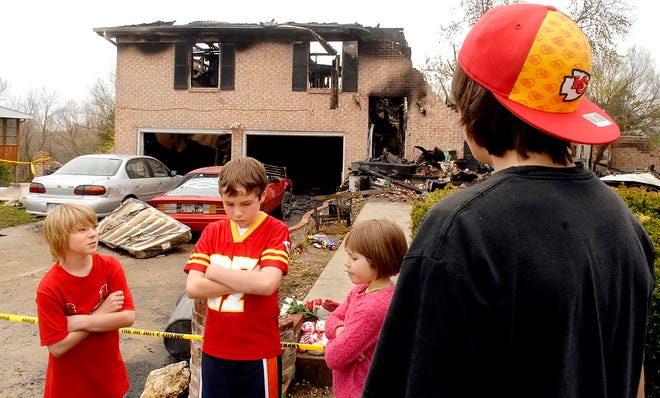 Neighborhood children in Holts Summit, from left, Nick Deppe, 10, Will Bolin, 10, Mia McBurney, 6, and Hunter Denich, 14, talk about their sense of loss Saturday since the fire on Lee Street.