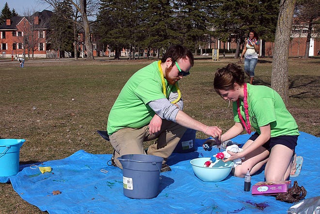 Garrett Munro and Victoria Szlag from the T.E.A. organization that promotes taking education abroad make preparations for Lake Superior State University resident advisers who wished to make their very own tie-dyed T-shirt. Friday’s campus activities also included games and a barbecue on the Brady Hall lawn.