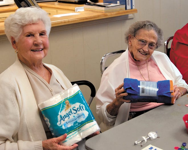 Sara Black, left, who claims her age is holding at 39, and Mae Lipscomb, 86, show off their prizes after last Thursday's monthly bingo competition of Greer Parks and Recreation Department's SOAR, Seniors Out and Around.