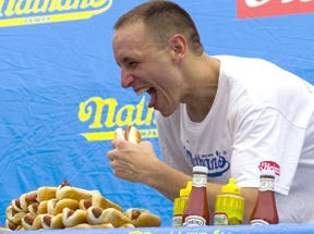 Hot dog eating champion Joey Chestnut, pictured, tied with six-time champion Takeru “Tsunami” Kobayashi by eating 59 hotdogs in 10 minutes. Chestnut prevailed in a tie-breaking five-dog “eat-off” held immediately after the contest.
