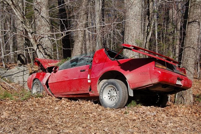 A late model Pontiac Firebird is shown after crashing into a tree off Squam Lake Road early Friday morning. A Moultonborough man was killed in the accident and a Sandwich man was transported by ambulance to Lakes Region General Hospital. (Bea Lewis/Citizen photo)