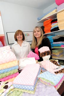 Sisters Cris Niedermeier, left, and JoDee Fluegel launched a business, Baby Talk Blankets, a few years ago. Their plush and fun products are taking hold and becoming must-haves for moms. Visit their store online at babytalkblankets.com or find their products at The Red Barn in Lena.