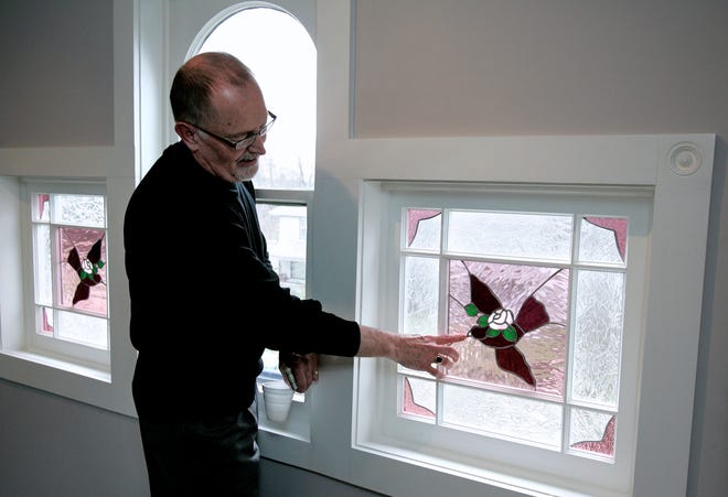 Bob Griffin points out the stained glass windows Monday, April 20, 2009, in the third floor of the home at 611 North Court St., during a tour of the home. The house is for sale with plans for $100,000 of the profit to be given to Victory Outreach.