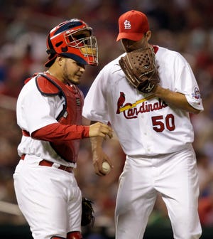 St. Louis Cardinals catcher Yadier Molina and starting pitcher Adam Wainwright talk on the mound during the fifth inning against the Chicago Cubs, Friday, April 24, 2009, in St. Louis.