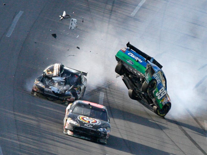 Carl Edwards (99) goes airborne after crashing with Ryan Newman, rear, and Brad Keselowski on the final lap of the Aaron's 499 on Sunday in Talladega, Ala.