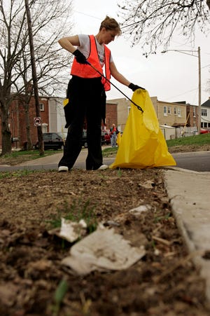Volunteer Marla Wilson of Rockford picks up trash and litter Saturday, April 25, 2009, along 12th Street between Fourth and Fifth avenues as part of a cleanup event sponsored by Keep Northern Illinois Beautiful in Rockford.