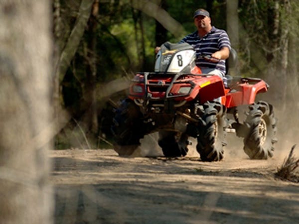 Stan Gurganus, one of the partners at Big Woods ATV Club, rides through the woods on some of the 3,000 acres at the club in Longwood Friday, April 24, 2009.