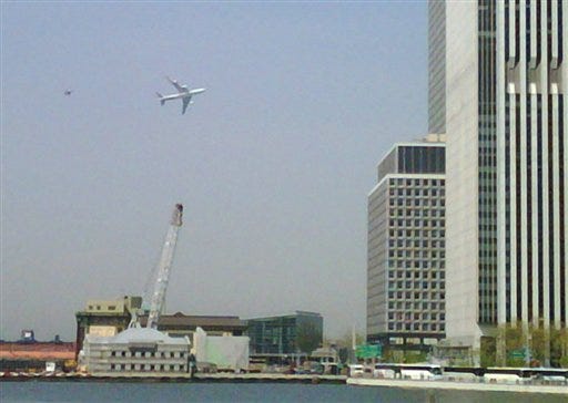In this image taken with a cell phone by Jason McLane, the primary presidential aircraft, a Boeing 747 known as Air Force One when the president is aboard, flies low over New York Harbor, followed by an F-16 chase plane during a federal government photo op Monday, April 27, 2009. A low-flying Boeing 747 escorted by two fighter jets as part of a federal government photo opportunity over lower Manhattan caused a brief panic among workers near ground zero on Monday. (AP Photo/Jason McLane)